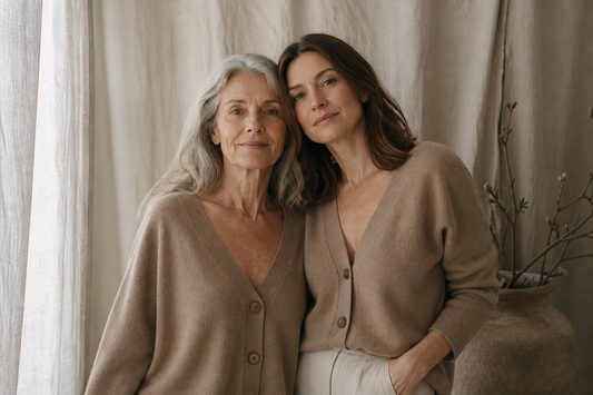 A woman in her sixties and her adult daughter wearing similar camel cashmere cardigans
